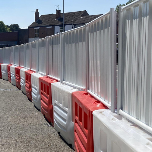 Oaklands RB2000 Barrier Solid Hoarding Panel, white and silver metal security fencing panels installed as a safety barrier along a construction or restricted area.
