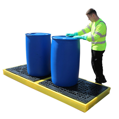 Romold BF4S 4 Drum Inline Low Profile Bunded Workfloor 300ltr Sump, image showing a worker inspecting two large blue drums placed on a durable bunded workfloor with a high visibility yellow edge.