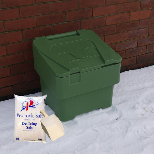 Excelsior 60 Litre Green Mini Grit Bin Inc Rock Salt & Scoop, green plastic grit and salt storage container with complimentary scoop and 25kg bag of de-icing salt on snowy ground next to brick wall.