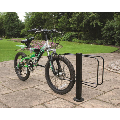 QMP Single / Double Floor Mounted Bicycle Rack, black metal bike parking stand securing a mountain bike outdoors on paved surface in park setting.