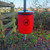 Melba Swintex 35L Doggy Waste Bin Post / Wall Mount, red waste bin with black dog symbol, mounted on a post outdoors