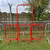 ZND 2.5m Spring Gated Site Access Walkthrough Barrier, red metal barrier with gate, used for site entrance control.