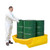 Romold 4 Drum Pallet Converter Bund PALCON4, a worker in protective gear handling a yellow pallet with four green drums for safe transport and storage.