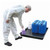 Romold 100 Litre Drip Spill Tray With Grid Mesh TT100G, image of a black spill tray with a grid mesh surface holding chemical bottles, with a person in protective gear handling the bottles.