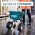 Cresco CR20SW 30kg High Output Salt Spreader, a person in orange safety jacket using a green salt spreader on a wet concrete surface in an outdoor storage area.