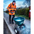 Cresco CR20SW 30kg High Output Salt Spreader, man in orange jacket and black gloves pushing a teal salt spreader on a rural sidewalk during winter.