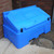 Excelsior 400 Litre Lockable Lidded Outdoor Storage Box, blue plastic storage chest placed outdoors near brick wall and concrete ground.
