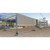 ZND 3.5m Eco Standard Temporary Heras Fence Panel, construction site security fencing with metal panels and yellow and black base supports at a building site under construction.