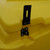 Excelsior 200 Litre Lockable Lidded Outdoor Storage Box, yellow outdoor storage container with black metal latch and attachment components.