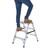 GPC 2 or 3 Tread Aluminium Folding Handy Steps, person standing on a durable, foldable aluminum step ladder with safety handles and non-slip feet for safe climbing and maintenance tasks.