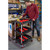 GPC Proplaz Workshop Tool Trolley inc 3 Trays, black and red portable workshop tool trolley with three shelves and multiple compartments for organizing tools, in a workshop setting.