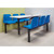 QMP 2, 4 or 6 Seat Canteen Tables, image showing a modern canteen table with blue plastic chairs and a white tabletop in a cafeteria setting.