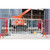 ZND Colour Powder Coated Crowd Control Barrier, white and red metal temporary fencing at construction site with heavy equipment in background.