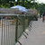 ZND Colour Powder Coated Crowd Control Barrier, green painted metal crowd control barrier placed outdoors, used for crowd management at events.