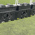 Site Supplies Mini Bison 1 Metre Water Filled Barrier 70kg, black plastic water barrier with large openings on the side for stability, positioned outdoors on grass near a metal fence.