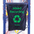 Beaverswood Racksack® Racking-Hung Warehouse Recycling Bags, black recycling bag with green print and recycling symbol, hanging on blue warehouse shelf for waste collection and recycling