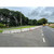 Elite Precast Concrete 1.2 Metre Concrete Jersey Lite Barrier, precast concrete road barriers lined along a rural roadway for traffic control