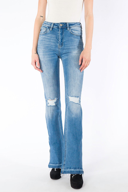 Medium-washed flare jeans crafted from soft denim with fading and distressed details at the knees, distressed hem, 5-pocket design, and single button closure with zip fly.