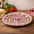 Galletto Red Deruta dinner plate set on formal dining table.
