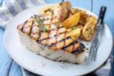 swordfish steak on a plate with grill marks