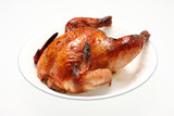 Roasted Cornish hen on a white plate