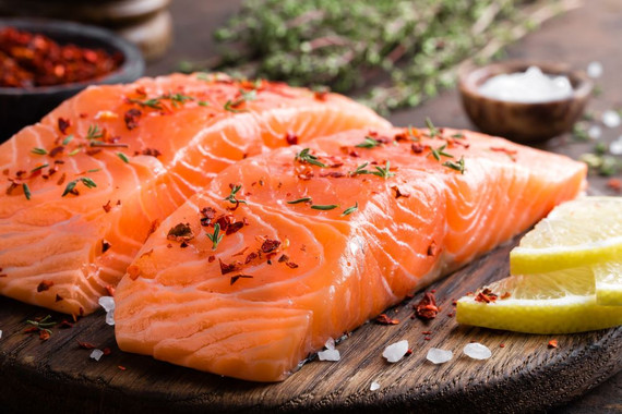 Atlantic Salmon fillets on a wood board