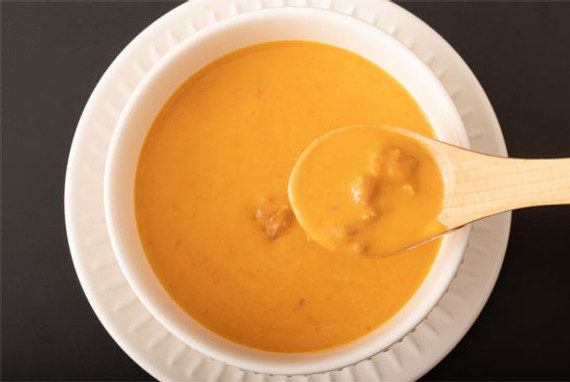 Bowl of lobster bisque in white bowl with spoon