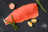 Frozen sockeye salmon fillet on natural stone slab