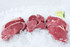 8 oz. filet mignons, 12 oz. boneless New York strip steaks, and 12 oz. boneless ribeyes in pairs on ice