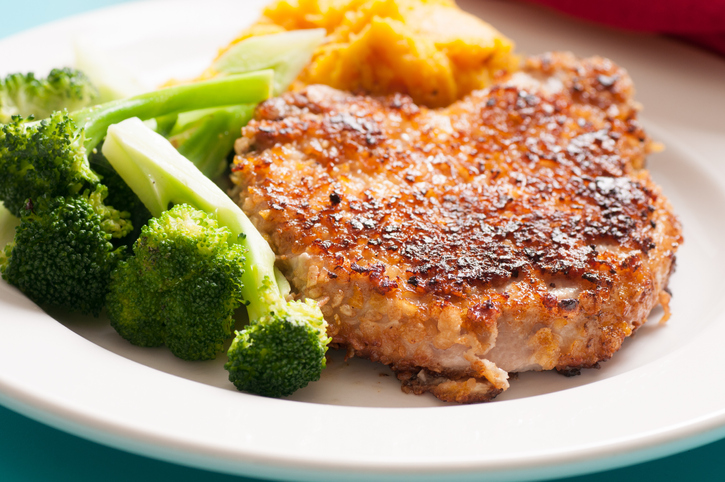 A plate of pork chops and squash