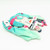 Top down angled view of the soft teal and pink Racing Miku 2025 plush strap pouch lying flat on a white background.