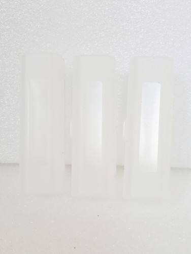 3 Clear Plastic 21700 Cases standing on end on white background. 3 Clear Plastic 21700 Cases standing on end on white background.