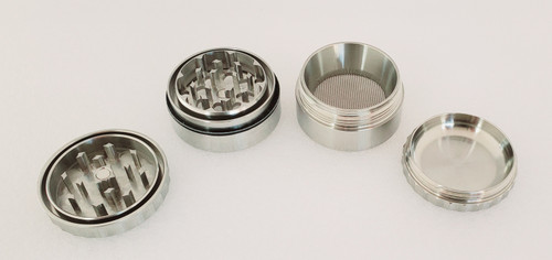 Iaso Goods Stainless Steel 1.75" 4 Piece Grinder disassembled with lid teeth facing upright and the remaining three pieces.  