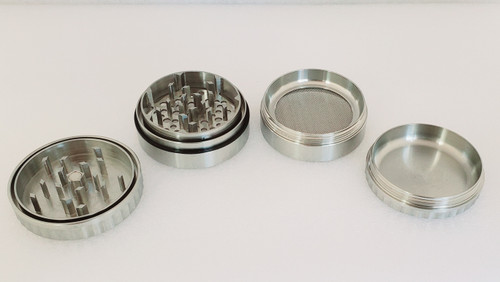 Iaso Goods Stainless Steel 2.5" disassembled from 4 pieces showing teeth of the lid facing up.