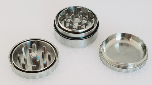 Disassembled 1.75" 3 Piece Iaso Goods Stainless Steel grinder disassembled with lid teeth pointing upward to show the tooth design