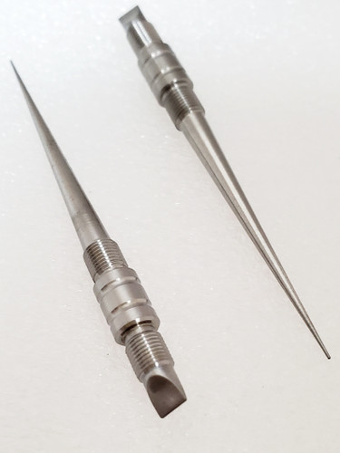Pair of Deluxe Titanium Toothpicks with point in foreground on right and inverted on left on white background.