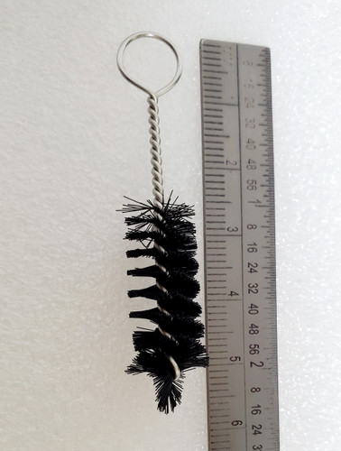 Mini Cleaning Brush on white background with ruler for scale