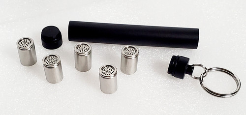 Disassembled Black Anodized Aluminum Travel Caddy with 5 XL Stainless Steel Dosing Capsules on white background