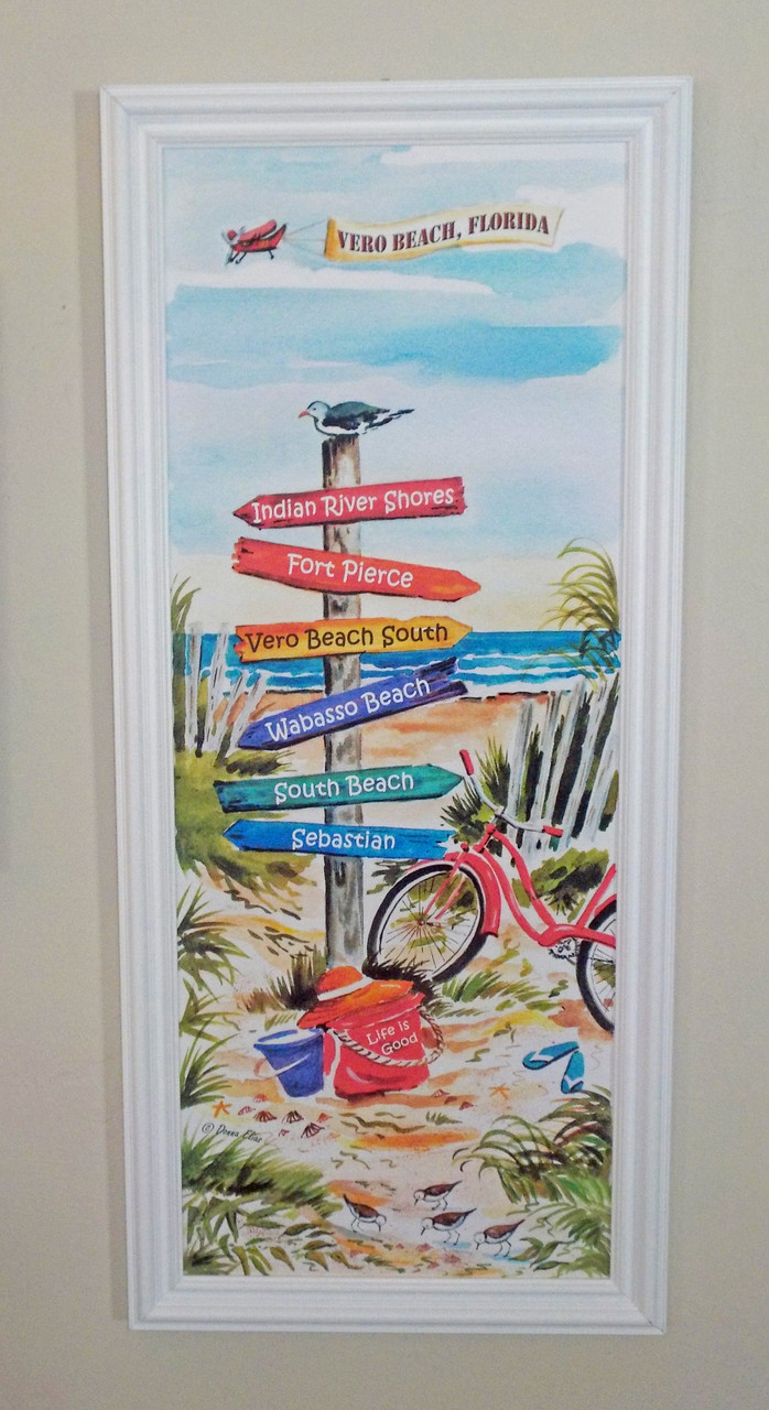 The Vero Beach Signpost is shown here in a white wood frame.