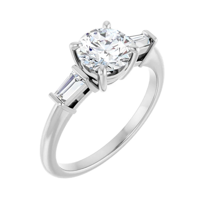 White gold, round and baguette three stone diamond ring