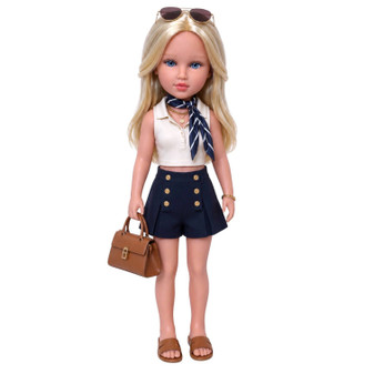Solange Moreau, a 32 cm Evia's World™ doll from Corsica, featuring long blonde hair and bright blue eyes. She wears an ivory designer sleeveless top with bra padding, a navy skort with decorative gold buttons, a navy striped neck scarf, brown sandals, and carries a coordinating designer handbag. Sunglasses rest atop her hair, completing her chic Mediterranean-inspired look.
