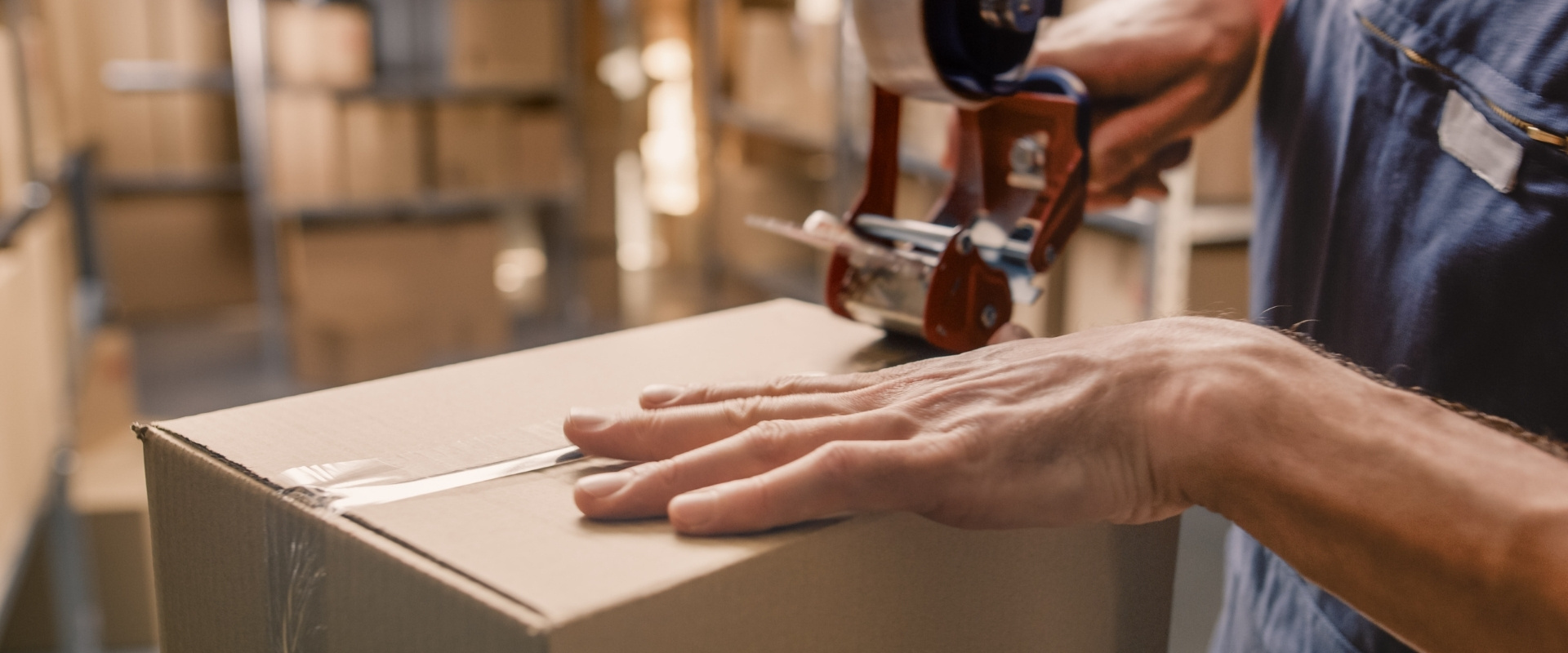 Package being sealed for shipment in a warehouse.
