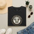 Folded 5 Star Pets centered vintage rescue dog crest t-shirt in black, styled with jeans and accessories.
