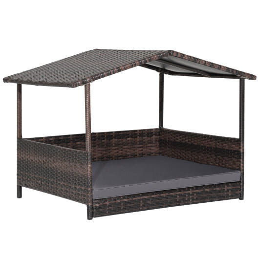 An elevated wicker dog house for small to medium breeds featuring a tan canopy and black base, designed for both indoor and outdoor use.