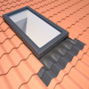 A VELUX curb-mounted skylight seamlessly integrated with a terracotta tile roof using the VELUX ECW flashing kit. The weathertight seal and professional finish enhance both the appearance and functionality of the skylight