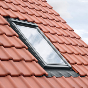 This image shows the Velux GDL MK19 balcony roof window installed on a tile roof with the EDW MK19 1000 flashing kit. The image highlights the seamless integration and weathertight seal achieved with the flashing This image shows the Velux GDL MK19 balcony roof window installed on a tile roof with the EDW MK19 1000 flashing kit. The image highlights the seamless integration and weathertight seal achieved with the flashing