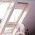 Interior view showcasing the clear-lacquered wood frame and natural light filling the space with the GDL PK19 Balcony Roof Window. Interior view showcasing the clear-lacquered wood frame and natural light filling the space with the GDL PK19 Balcony Roof Window.