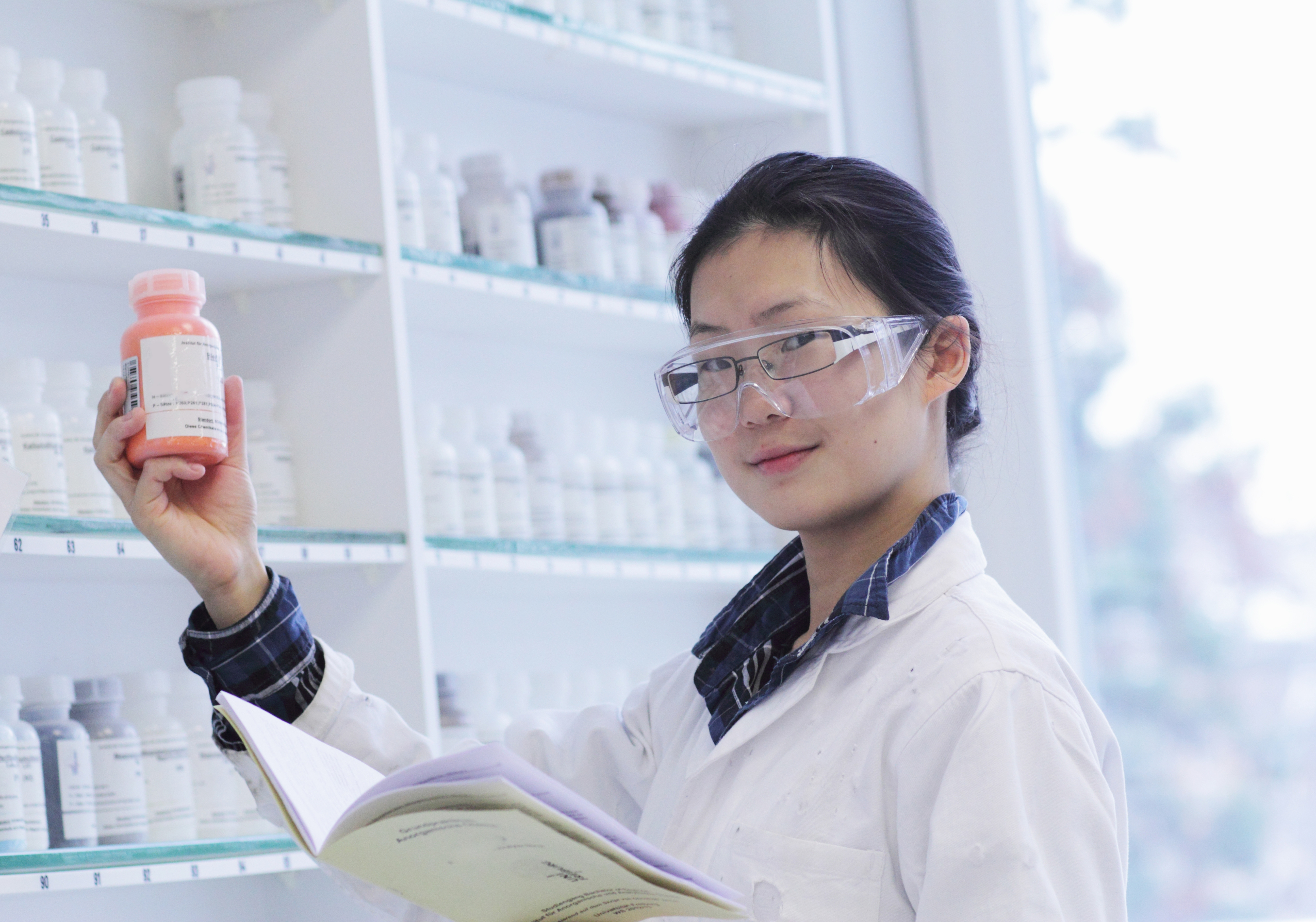 Emily -holding-bottle-in-lab-