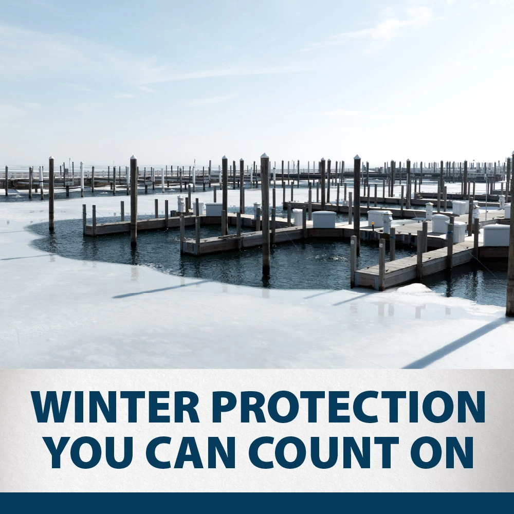 Winter marina with open water around docks surrounded by ice, illustrating Airmax Ice Eater protection for docks and marina structures.
