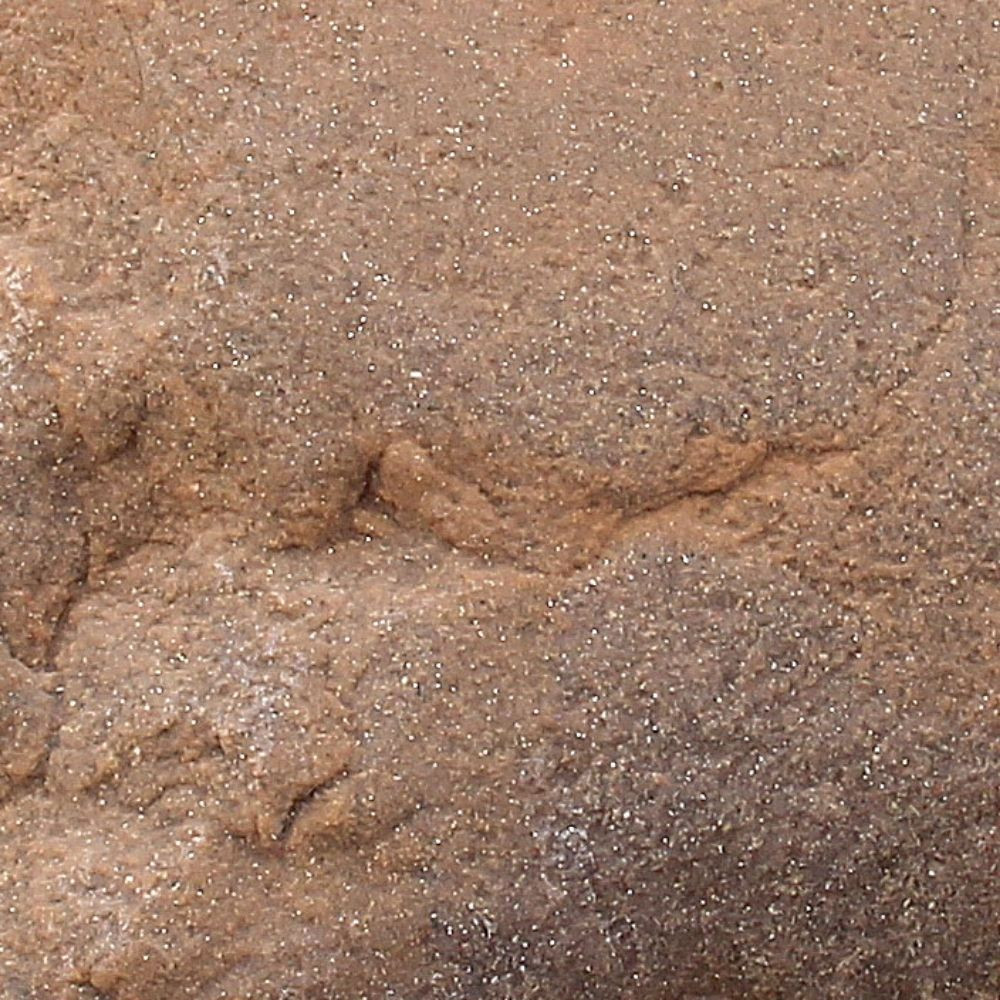 Close-up of DekoRRa’s Autumn Bluff faux rock texture, a warm, brownish hue ideal for blending into outdoor environments and hiding utilities.
